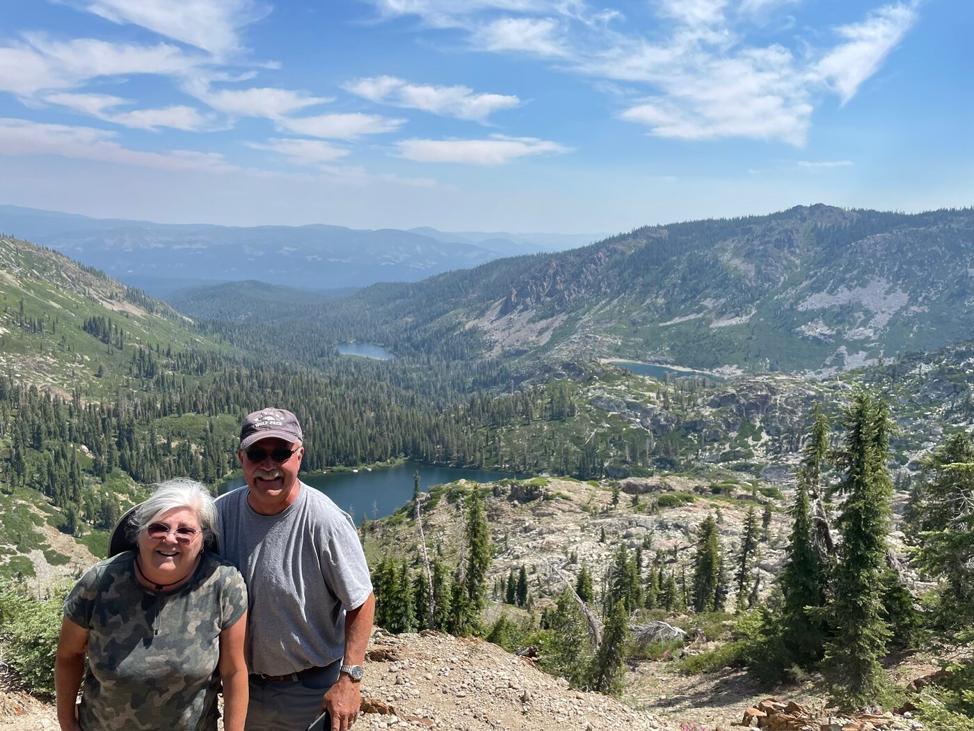 Andrea and Dan hiking together above mountain lakes