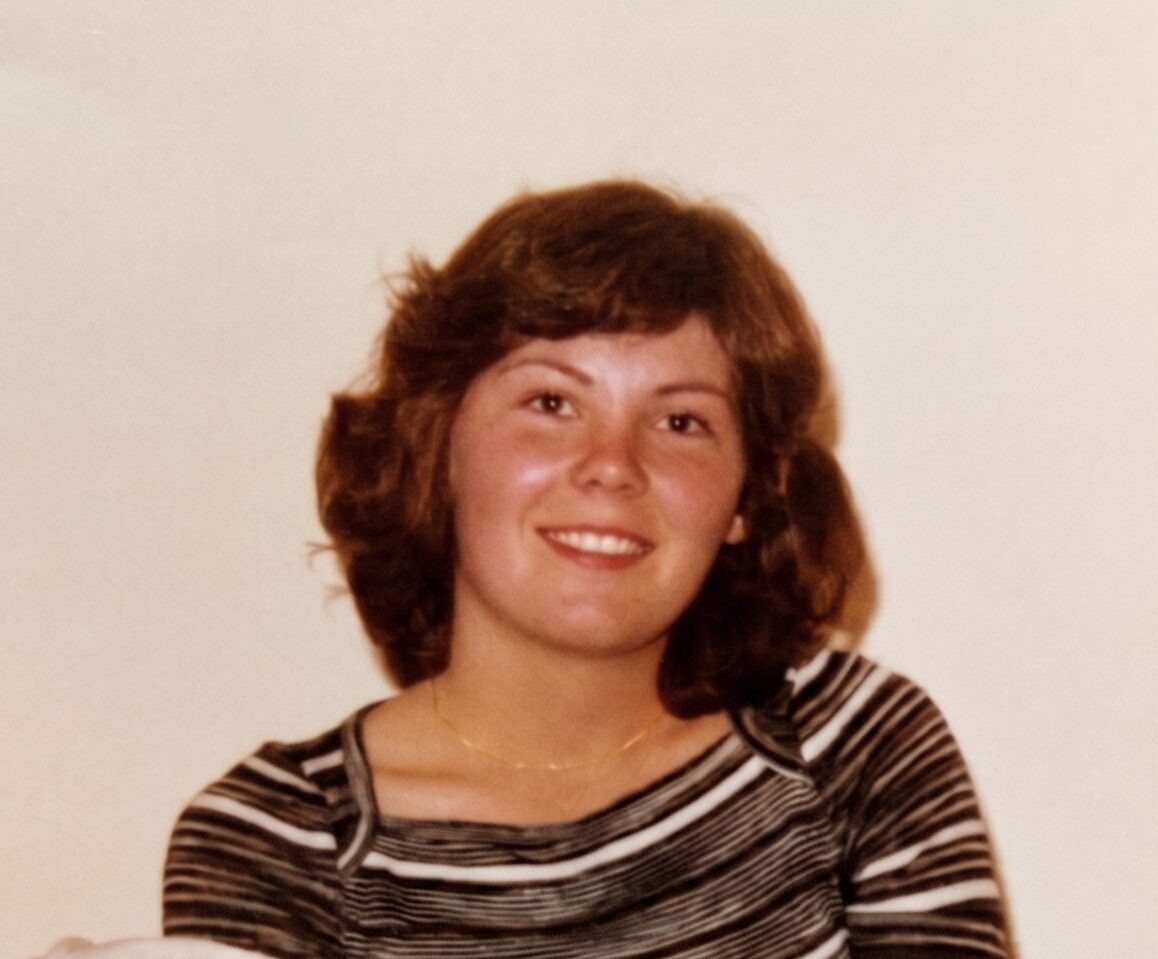 A vintage portrait of a young Andrea smiling