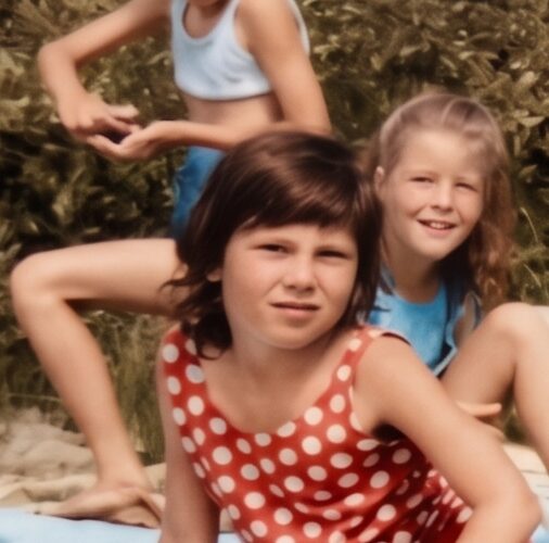A young Andrea with other children on a summer day